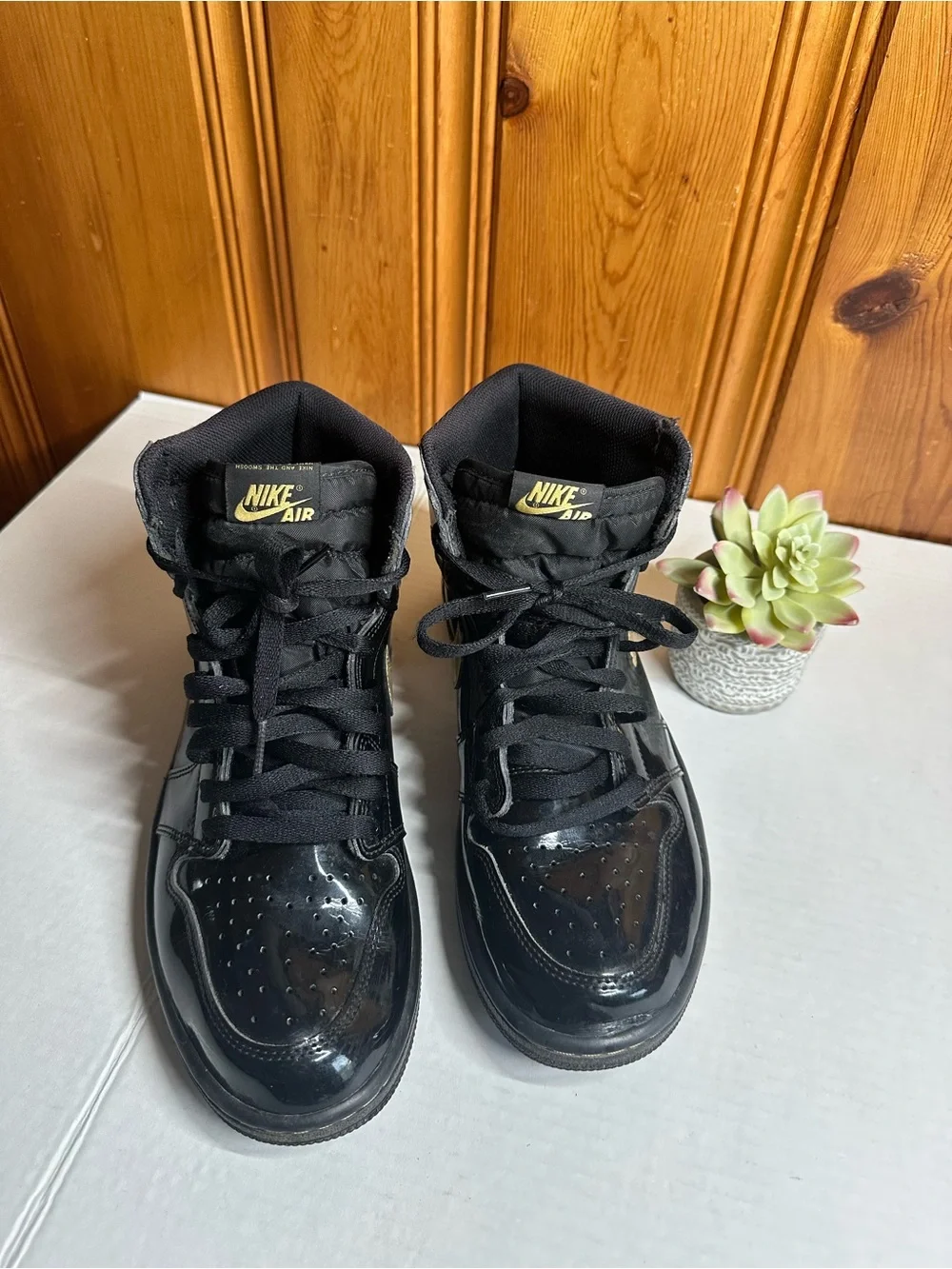 Nike Air High-Top Sneakers in Black with Gold Logo